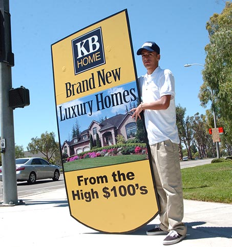 Young man with human directional advertising, about real estate sale